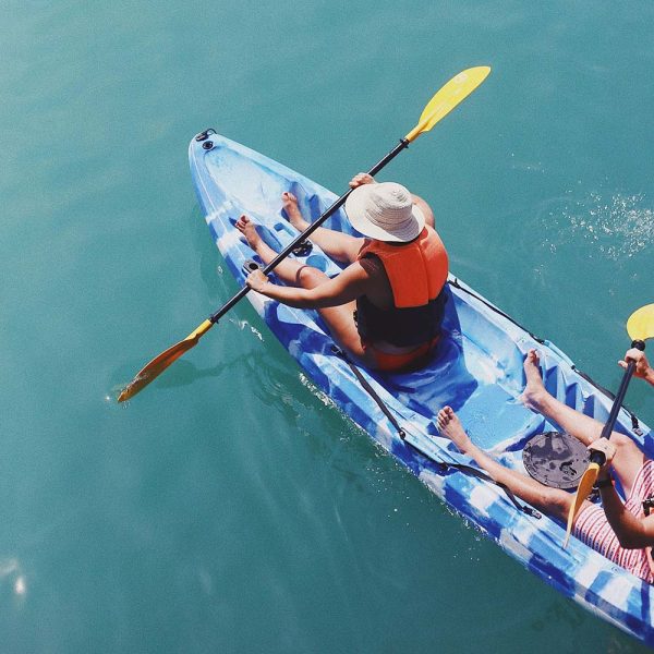 2 people in kayak aqua water